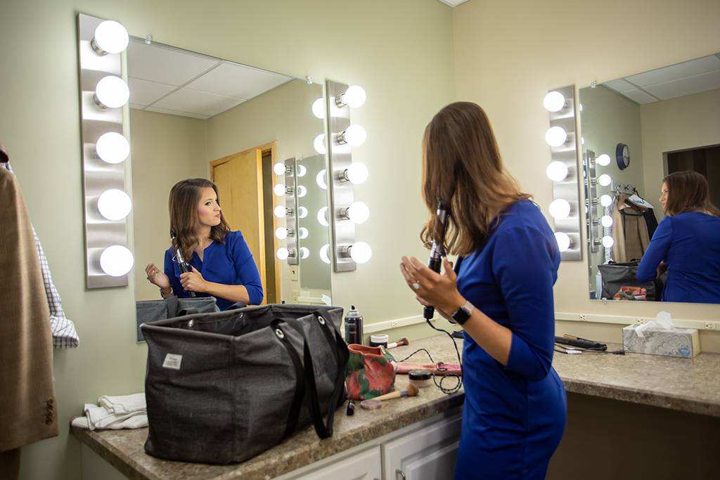 Lydia Blume readies for the morning news in the make-up room